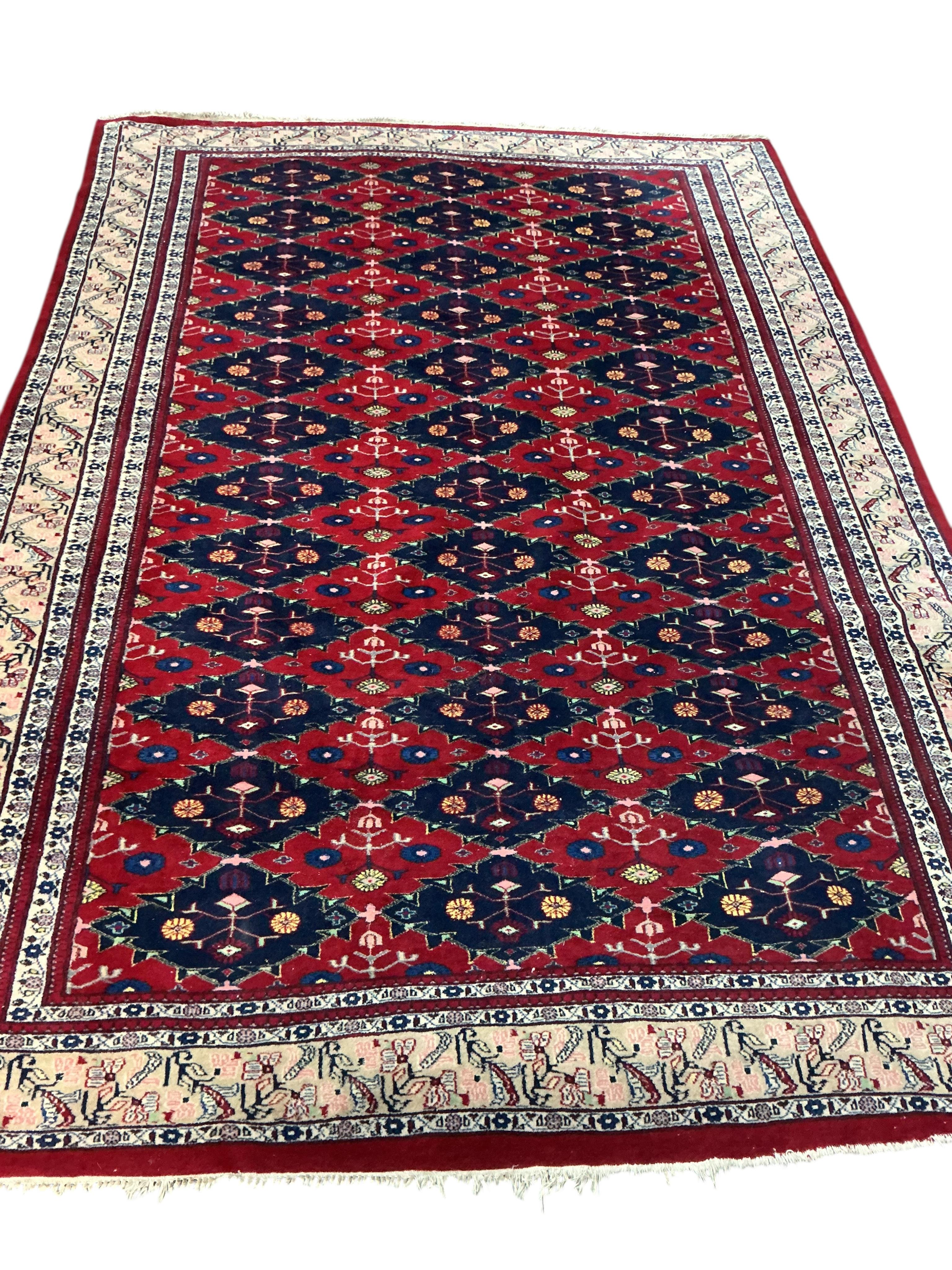 An Afghan red ground carpet, 270 x 188cm